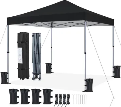 A black pop-up canopy tent is set up on a white background, with its folded frame and accessories laid out nearby.