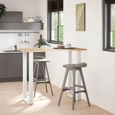 A modern kitchen with a breakfast bar and stools.