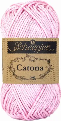 A ball of pink yarn with a brown paper label.
