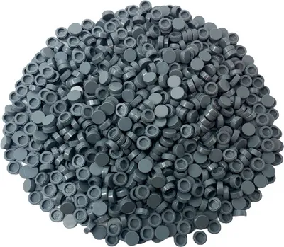 A pile of small, round, dark gray LEGO tiles.