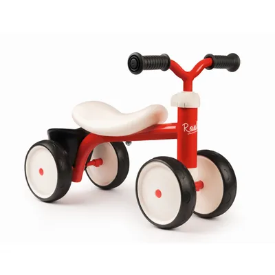 A red and white toddler ride-on toy with black wheels, shown from a side-front angle against a white background.