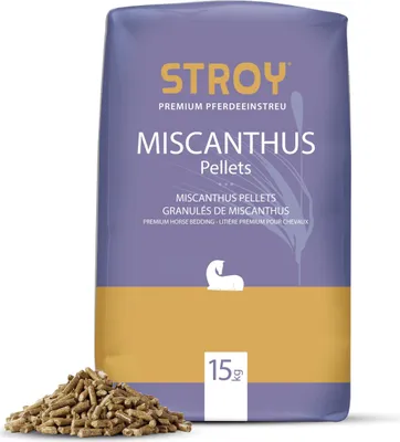 A bag of Miscanthus pellets for horse bedding, with a pile of pellets in front.