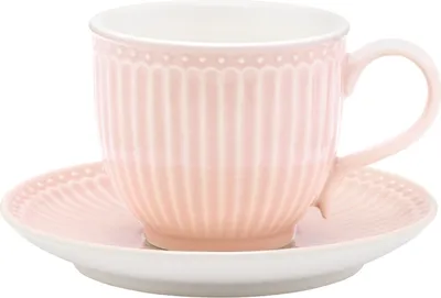 A pink teacup and saucer set against a white background.