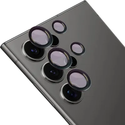 A close-up view of several camera lens protectors arranged on the back of a smartphone.