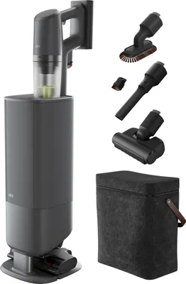A vacuum cleaner with its charging station and accessories, displayed against a white background.