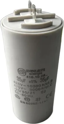 A close-up studio shot of a white capacitor with metallic connectors on top.