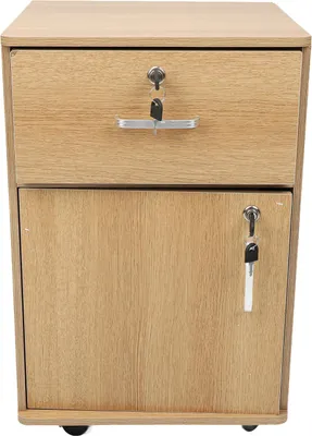A close-up, front-facing view of a light brown, wooden mobile filing cabinet with one drawer and one cabinet door, both featuring locks and keys.