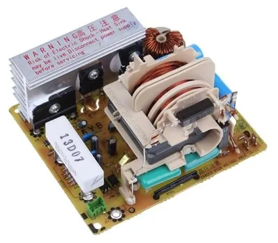 A close-up view of an electronic circuit board with various components, including transformers, capacitors, and a heatsink.
