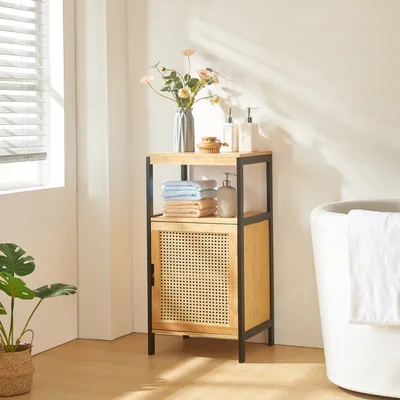 A bathroom scene with a cabinet, bathtub, and plant.