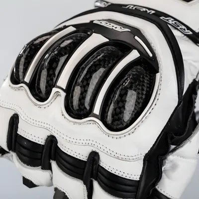 A close-up view of a motorcycle glove, showing the protective knuckle guards.