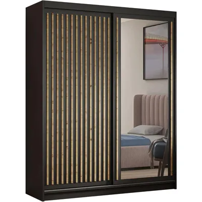 A wardrobe with sliding doors, one of which is mirrored, reflecting a bedroom scene.