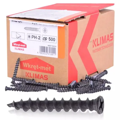 A box of screws with some screws scattered in front of it.