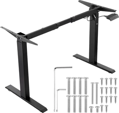 A black electric standing desk frame with included hardware and tools, displayed on a white background.