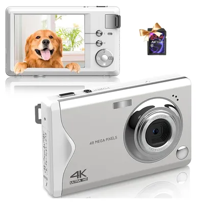 A white digital camera is shown from the front and top, with a second camera showing a dog on its screen. A memory card is also visible.