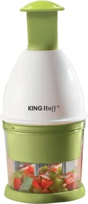 A white and green vegetable chopper with chopped vegetables inside.
