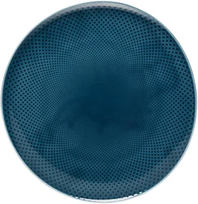 A top-down view of a round, flat plate with a textured pattern.