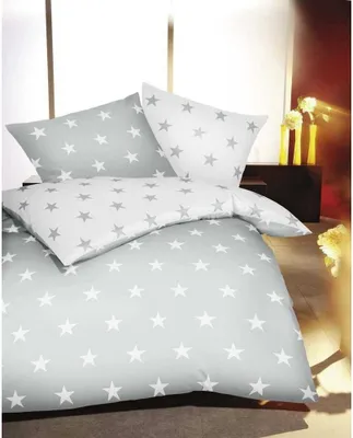 A bed with star-patterned bedding.