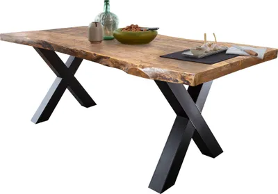 A wooden dining table with black X-shaped legs, set against a white background.