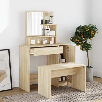 A vanity table with a mirror and stool, along with decorative items and a potted plant, in a room setting.