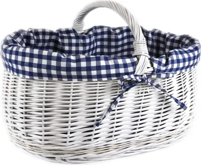 A white wicker basket with a blue and white gingham fabric lining and a bow.