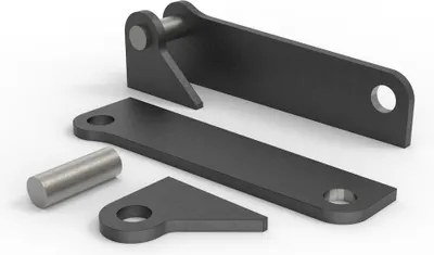 Several metal parts for machinery are laid out on a white and gray surface.