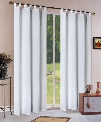 White curtains hanging in front of a window with a view of a garden.