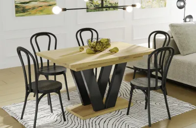 A dining table with chairs in a modern room setting.