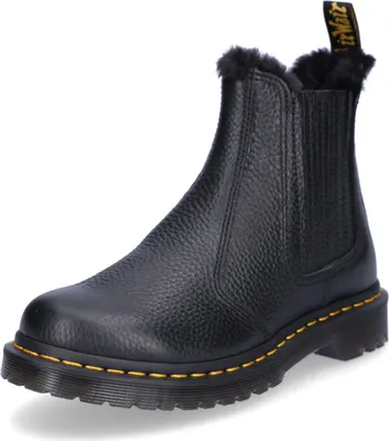 A black Dr. Martens boot with fur lining.