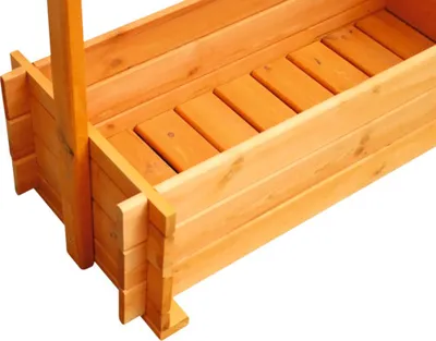 A close-up view of a wooden planter box with a trellis.