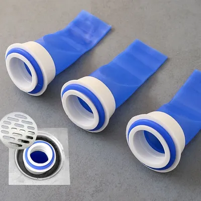 Three blue and white drain backflow preventers are arranged on a gray surface. A small inset image shows one of the devices installed in a sink drain.