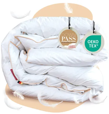 A folded white duvet with beige trim, presented with marketing tags and decorative feathers.