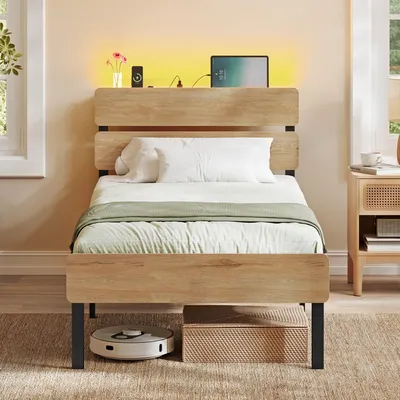 A bedroom scene with a bed, nightstand, and robot vacuum.