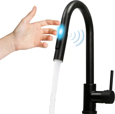 A hand is shown activating a motion-sensor kitchen faucet, which is dispensing water.