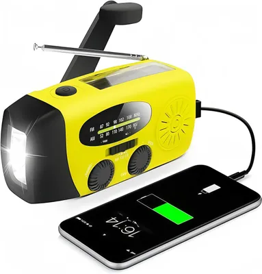 A yellow and black emergency radio is shown connected to a smartphone, which is charging.