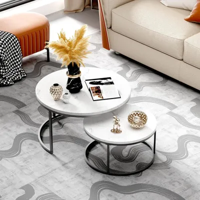 A living room setting with a sofa, coffee table, and ottoman.