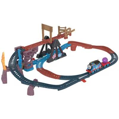 A toy train set with tracks, bridges, and a train engine.