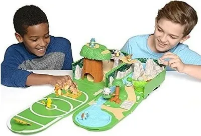 Two boys playing with a Pokemon playset.