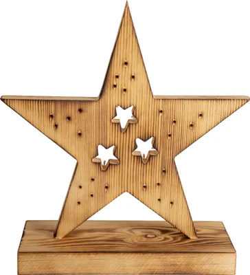 A wooden star decoration with cut-out stars, placed on a wooden base.