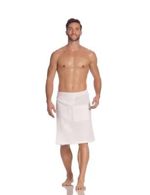 A man wearing a white sauna kilt stands against a white background.