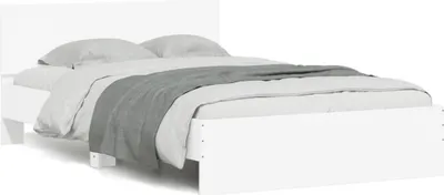A white bed frame with gray bedding and a gray throw blanket, shown from the side.