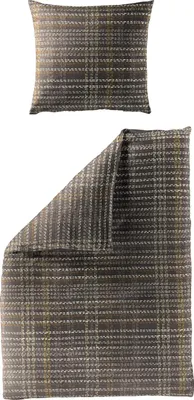 A pillow and a folded duvet cover with a plaid pattern.