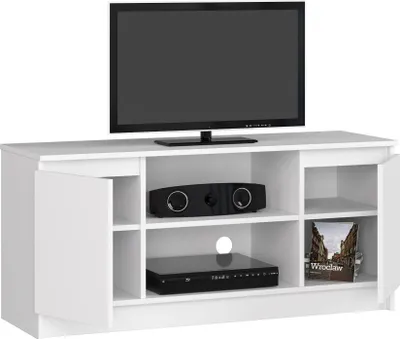 A white TV stand with a television on top and electronic devices inside.