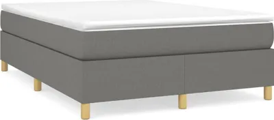 A boxspring bed frame with a mattress on top, shown from a side angle on a white background.
