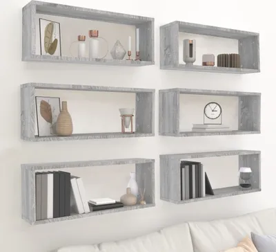 Six cube shelves are mounted on a white wall, displaying various decorative items.