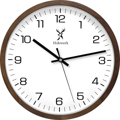 A close-up studio shot of a round wall clock with a brown wooden frame and a white face.