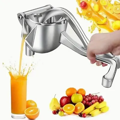 A hand is shown using a manual juicer to extract juice from fruit. A glass of orange juice is being filled, and various fruits are arranged at the bottom right of the image.