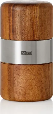 A close-up studio shot of a wooden and metal spice grinder.