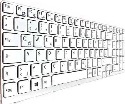 A close-up, angled view of a white keyboard.