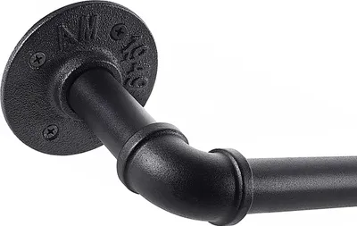 Close-up of a black industrial-style curtain rod bracket and pipe.