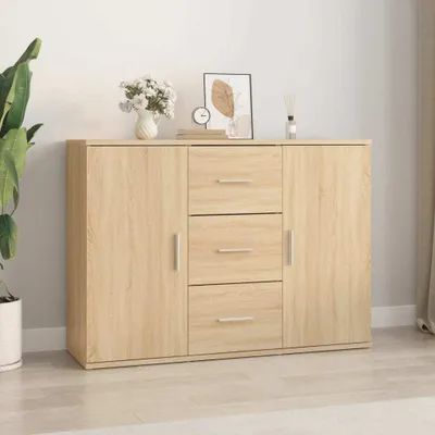 A wooden sideboard with drawers and doors, decorated with a vase of flowers, a framed picture, and a clock on top.